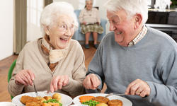 © Monkey Business - fotolia.com Senior Couple Enjoying Meal Together