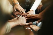 closeup-of-diverse-people-joining-their-hands