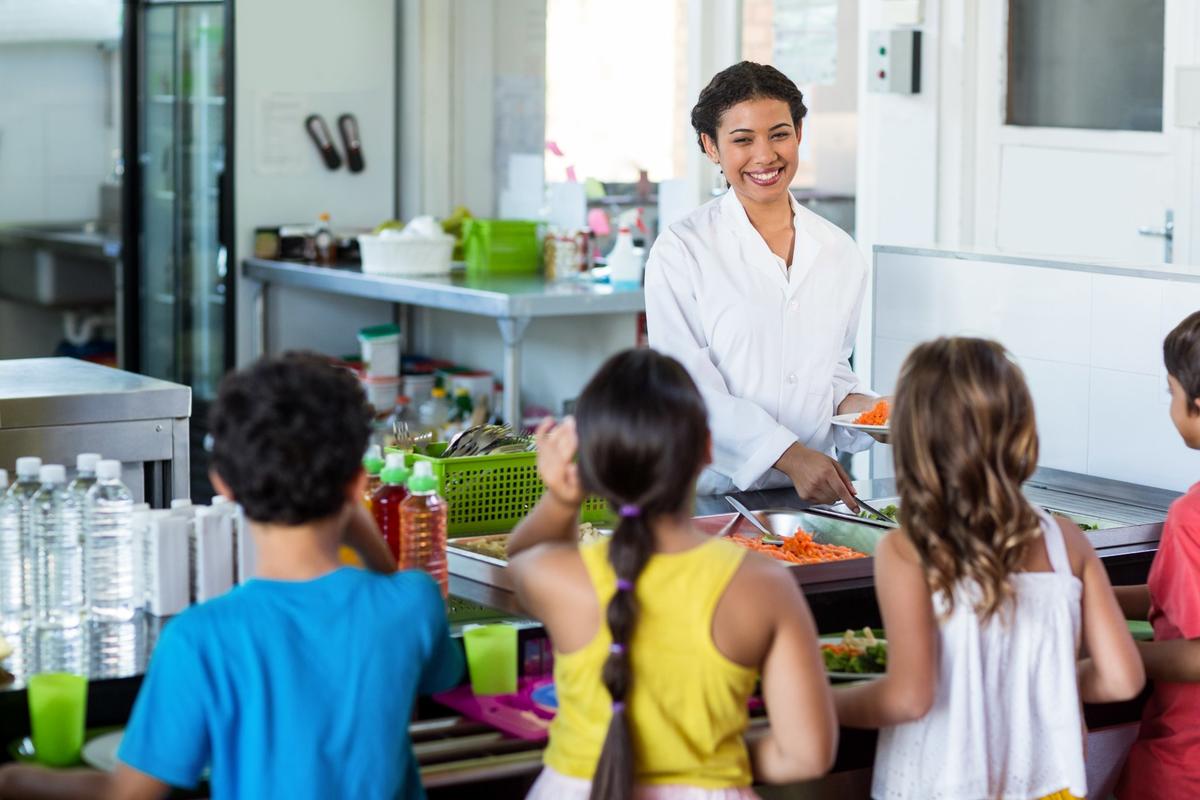 woman-serving-food-schoolchildren